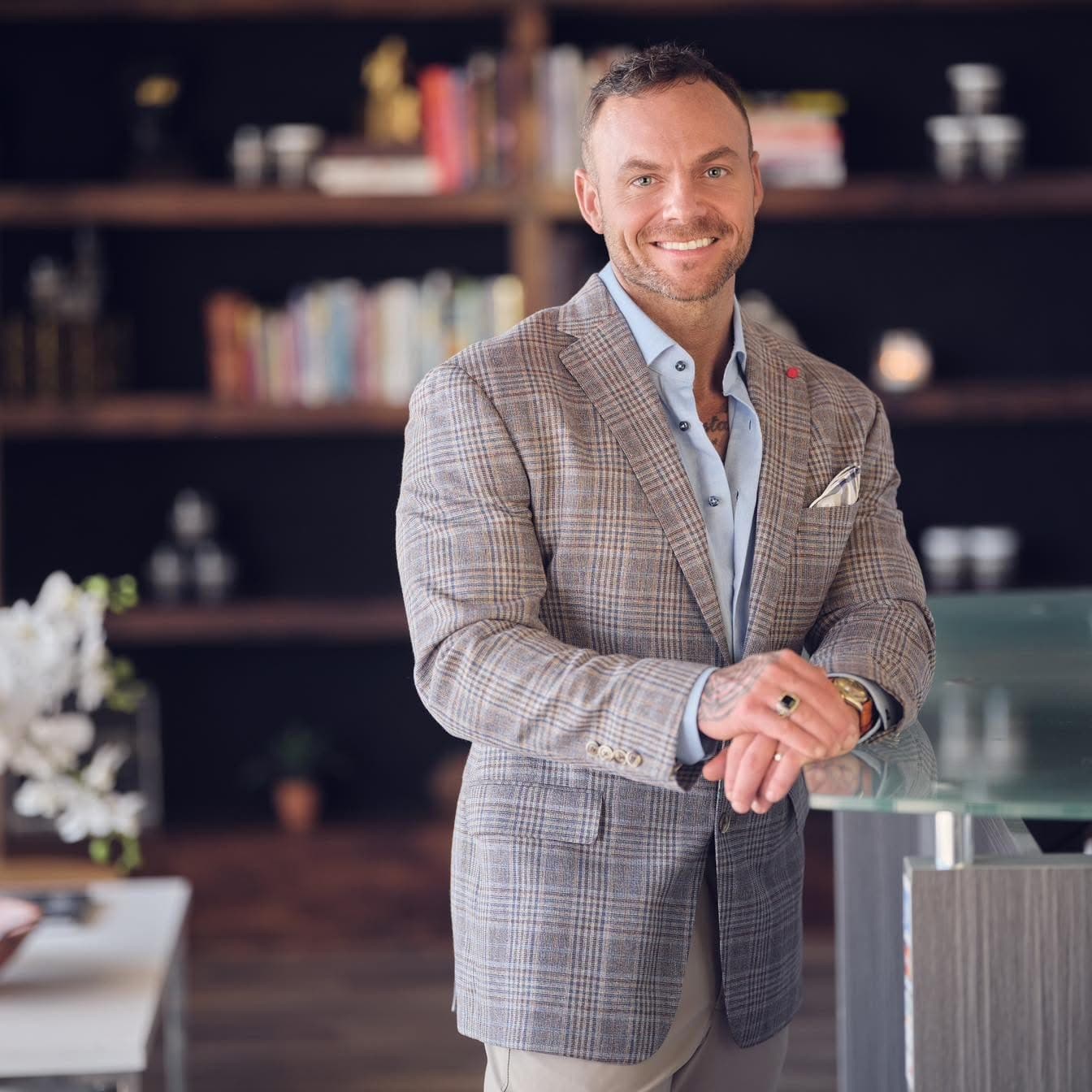 Chase Bergner, founder and CEO, photographed in a warm-lit library setting.